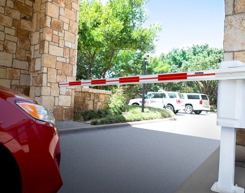 Commercial barrier arm gate operator at a parking entrance