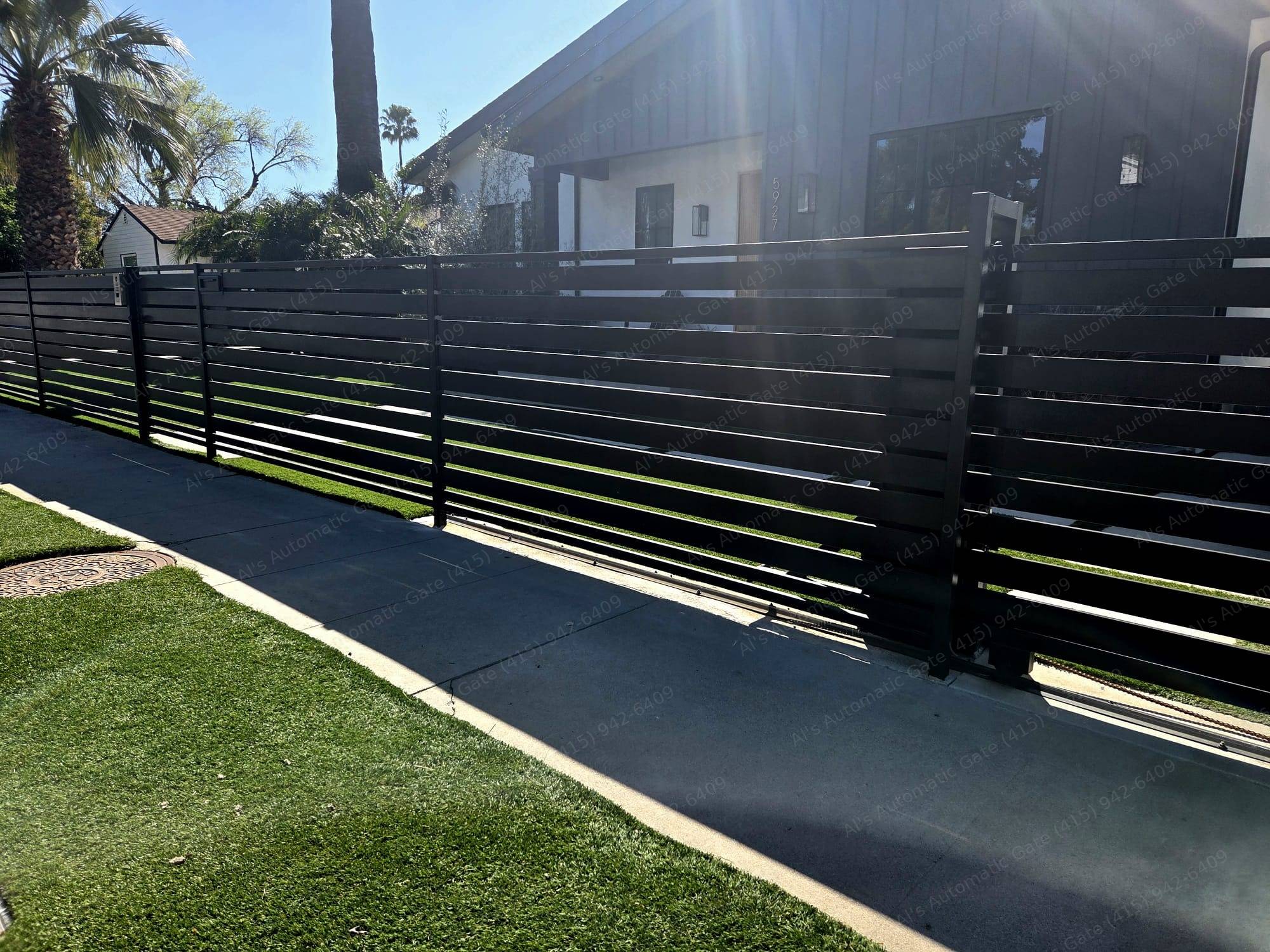 Black horizontal-slat automatic sliding gate
