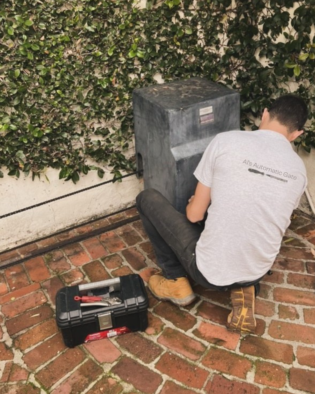 Al's Automatic Gate technician servicing a slide gate operator