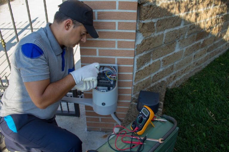Technician wiring a swing gate operator control board